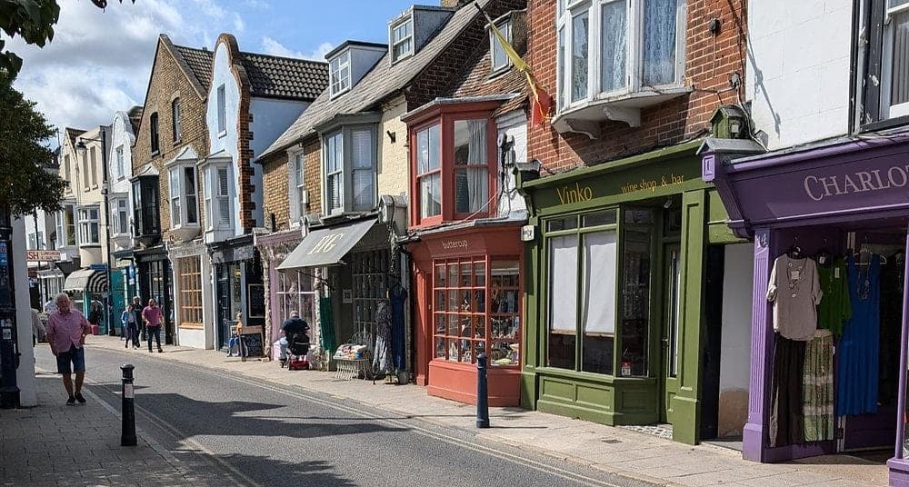 A high street of independent shops with painted shopfronts in different colours